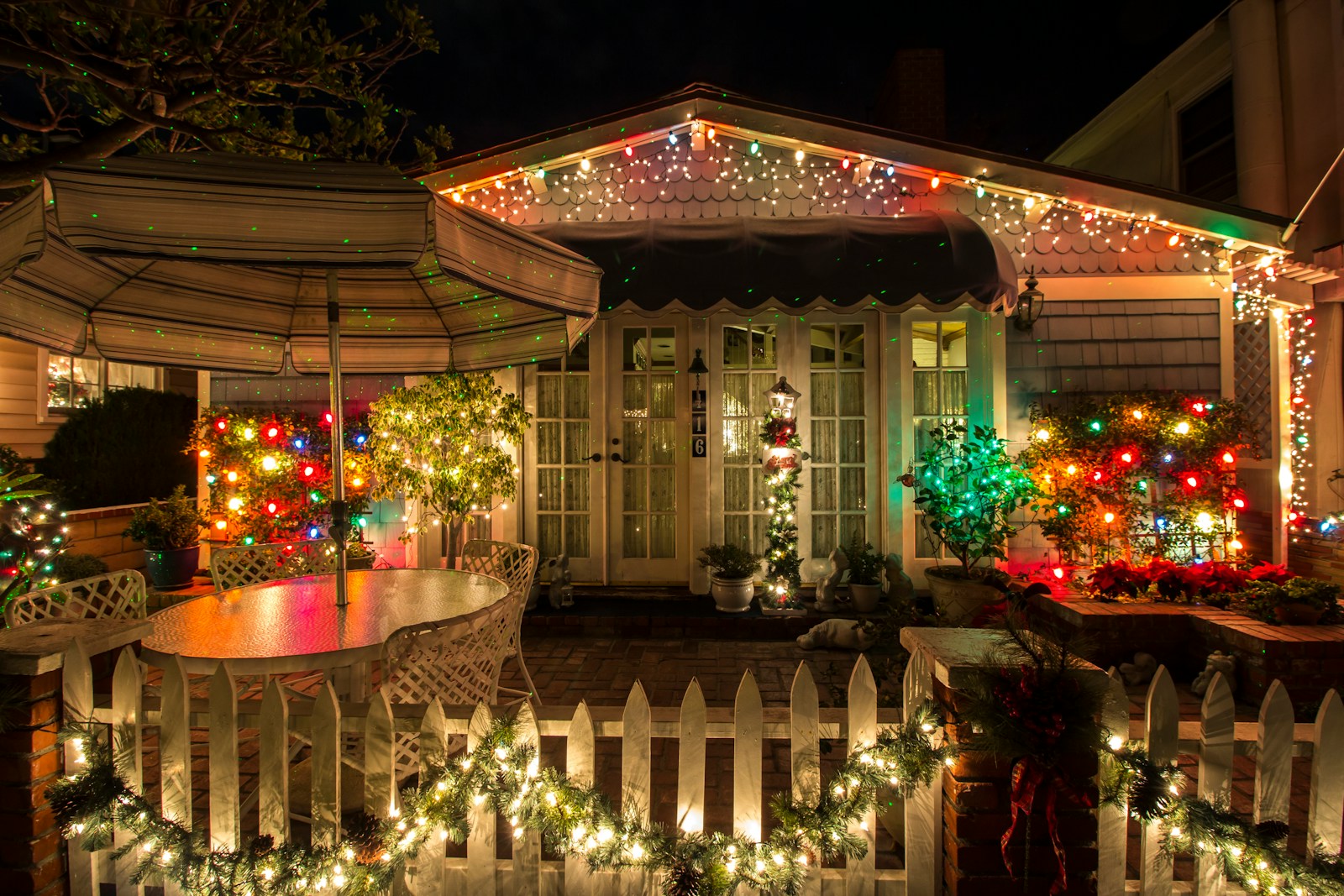 Storefront with garland and warm white Christmas lights